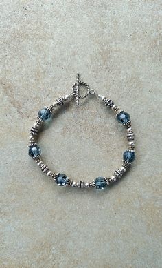 "Balinese sterling silver jewelry with Swarovski crystals, toggle bracelet, one of a kind vintage bracelet Sterling Silver, Bali sterling silver and Swarovski crystal handmade beaded bracelet, 7.5\" All beads are sterling with bali sterling beads and bead caps. Toggle clasp is also bali sterling. Swarovski crystals are indian sapphire 8mm faceted round. Check out my other jewelry at https://loveofjewelryshop.etsy.com" Faceted Sterling Silver Beaded Bracelets For Jewelry Making, Handmade Silver Beaded Bracelets For Anniversary, Silver Sterling Bracelets With Faceted Beads, Elegant Sterling Silver Nickel Free Crystal Bracelet, Faceted Silver Bracelet, Silver Round Beads Crystal Bracelet For Anniversary, Sterling Silver Bracelets With Faceted Beads, Silver Crystal Bracelet With Round Beads For Anniversary, Classic Bracelets With Sterling Silver Clasp For Jewelry Making