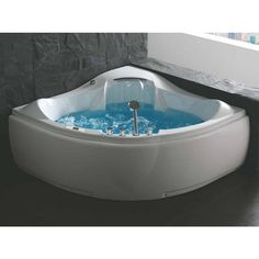 a large white bath tub with blue water in it