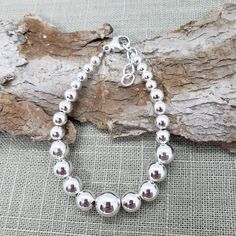 "Beautiful! Classy, simple everyday wear. Adjustable all shiny round ball sterling silver bead bracelet. Perfect  gift 🎁 for that special someone who you may not know their wrist size. Several bead sizes from 10mm - LARGE size bead - 5mm MEDIUM size beads   MEASURE WRIST: wrap string around wrist (not tight) see photo.  SUGGEST adding about 1/2\" to see which bracelet will work for you.  Length measured from clasp to extender link - NOT bead to bead  📌PLEASE SEE LAST PHOTO for what 7\" - 8\" l Nickel-free Classic Beaded Bracelet As Gift, Classic Nickel-free Beaded Bracelets As Gift, Silver Bracelets With 8mm Beads For Everyday, Everyday Silver Bracelets With 8mm Beads, Minimalist Sterling Silver Bracelet With Spacer Beads, Adjustable Ball Chain Beaded Bracelet For Gift, Adjustable Beaded Bracelet With Ball Chain For Gifts, Adjustable Ball Chain Beaded Bracelets As Gifts, Sterling Silver Bracelet With Round Spacer Beads For Everyday