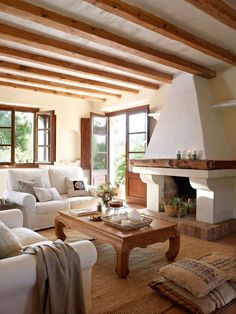 a living room filled with furniture and a fire place in the middle of a room