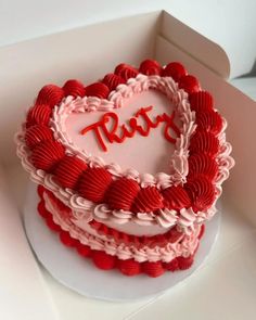 a heart shaped cake with the word ruby written on it