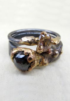 a close up of two rings on top of each other with a stone in the middle