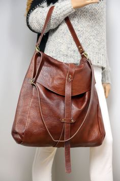 This large brown leather bag can be used as a bag, backpack or crossbody. Perfect for everyday life, for travel or school. Dimension details: Max width at the top: 14,5 inch Height: 15,5 inch Width at the base: 14,5 inch Depth: 5,5 inch Short strap:18 inch Long strap:60 inch A great everyday bag with a minimalist look it can be worn as a bag, backpack or crossbody. - Brown color - Made of thick yet soft cattle leather. - Inside cotton lining - Top closure magnet for security Add this gorgeous ba Convertible Backpack Purse, Large Leather Bag, Large Travel Bag, Brown Leather Backpack, Large Crossbody Bags, Leather Travel Bag, Large Leather Tote, Convertible Backpack, Black Leather Backpack