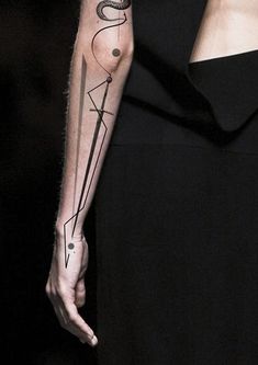 a woman's arm with a tattoo on it and an arrow in the middle