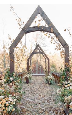 an outdoor wedding ceremony with flowers and greenery