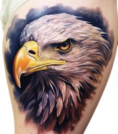 an eagle tattoo on the side of a woman's thigh