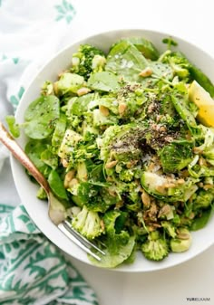 a white bowl filled with broccoli and other vegetables