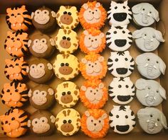 a box filled with lots of cupcakes decorated like animals