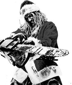 a man dressed as santa claus holding a chainsaw