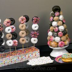 there are donuts on the table next to each other with sprinkles