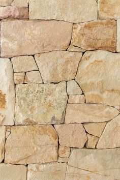 a stone wall that is made out of different types of rocks and has been used as a background