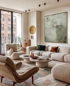 a living room filled with lots of furniture and large windows overlooking the cityscape