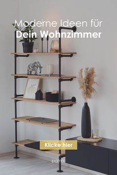 a book shelf with books and plants on it, in front of a white wall