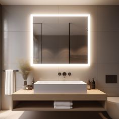 a bathroom with a sink, mirror and toilet in the background is lit by lights on the wall