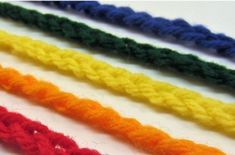 four different colors of crochet are shown in this close up photo, the yarn is multicolored