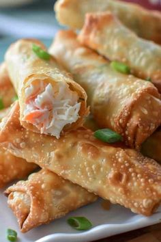 some food is on a white plate and ready to be eaten with chopsticks