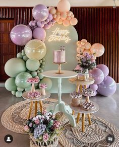 an assortment of desserts and balloons on display at a birthday party