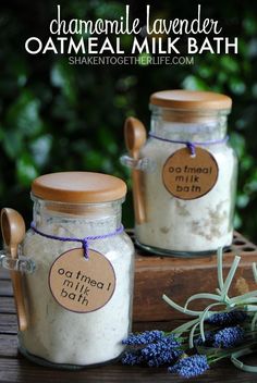 two jars filled with oatmeal milk sitting on top of a wooden table