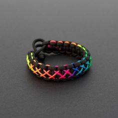 a rainbow bracelet on a black surface