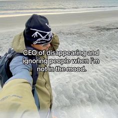 a person walking in the sand with a backpack on their back and a quote written above it