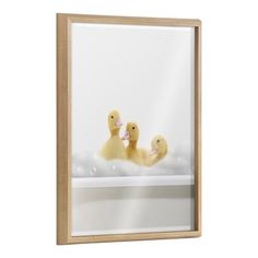 three ducks in a bathtub with bubbles floating on the water framed canvas wall art print