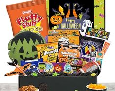 a halloween gift box filled with snacks and treats, including candies in a bowl