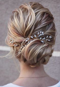 a woman with blonde hair wearing a gold leaf headpiece in her left side view