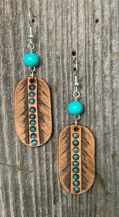 Hand tooled brown leather earrings with turquoise highlights and hypoallergenic ear wires. Hand Tooled Adjustable Dangle Earrings, Hand Tooled Leather Earrings As Gift, Southwestern Hand Tooled Earrings For Gift, Rustic Hand Tooled Leather Earrings, Hand Tooled Teardrop Bohemian Earrings, Turquoise Highlights, Wood Jewelery