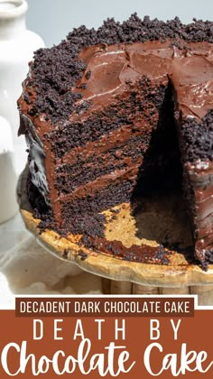 a chocolate cake on a plate with the words decadent dark chocolate cake cut in half