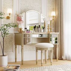 a vanity table with stool and mirror in a room next to a vase filled with flowers