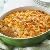 a green dish filled with macaroni and cheese