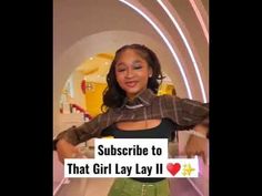 a girl is standing in front of a sign that says subscribe to that girl lay lay ii