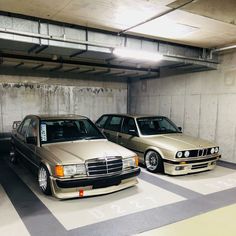 two cars parked next to each other in a parking garage