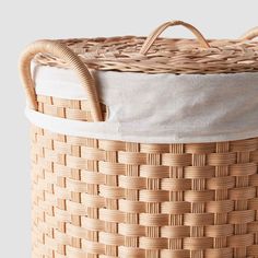 a woven basket is shown with handles on the top and bottom, along with a white lining