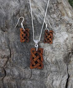 "This beautiful and unique hand-carved wooden Celtic knot jewelry set will be made for you, or a loved one, in my studio on the West of Ireland. These dainty rosewood Celtic necklace & earrings are recycled from musical instruments constructed by a local luthier. As a musician myself, I take enormous satisfaction in creating a jewelry set whose inherent wood has previously featured in a beautiful hand-made guitar. Also, part of rosewood's attractiveness is its durability and ability to stand Handmade Wooden Pendant Jewelry, Handmade Artisan Wood Jewelry, Artisan Wooden Jewelry As A Gift, Artisan Handmade Wooden Jewelry, Handmade Artisan Mahogany Jewelry, Artisan Wood Jewelry Gift, Artisan Handmade Mahogany Jewelry, Rustic Wooden Beads Jewelry As A Gift, Traditional Handmade Natural Wood Jewelry