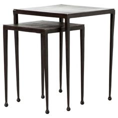 a set of three nesting tables with one end table on each side and the other in black