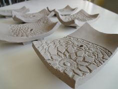 several pieces of white pottery sitting on top of a table