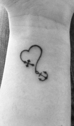 a heart with an arrow tattoo on the wrist is seen in this black and white photo