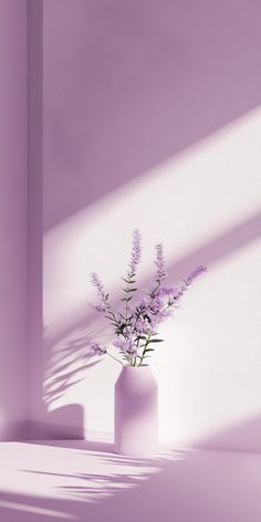 a vase with some flowers in it sitting on a table next to a purple wall