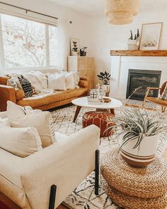 a living room with couches, chairs and a fire place in the center area