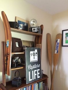 there is a sign that says explore life next to bookshelves and paddles