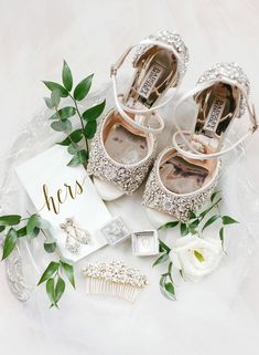 the bride's wedding shoes and accessories are laid out on a white tablecloth