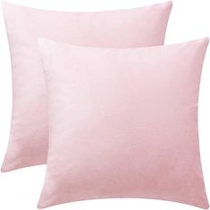 two pink pillows sitting next to each other