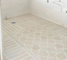 a bathroom with white walls and tile flooring