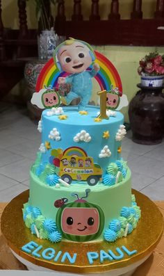 a three tiered cake decorated with an image of a child's first birthday