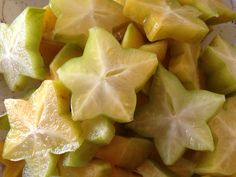 cut up pieces of fruit sitting on top of a white and blue plate with star designs