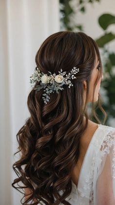 a woman with long brown hair wearing a flowered headpiece and white flowers in her hair