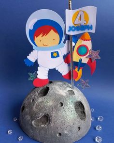 a little boy in an astronaut suit standing on the moon with a flag and stars