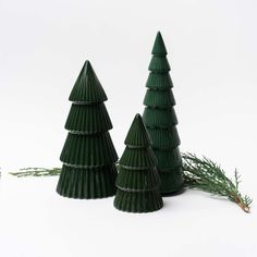 three green plastic christmas trees sitting next to each other