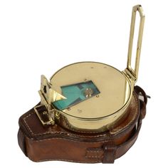 an antique brass plated compass with leather case